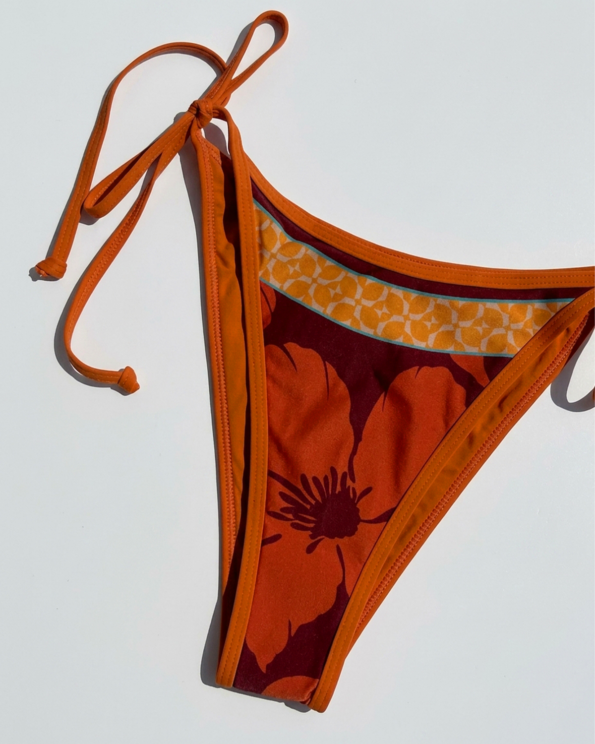 Close up flat lay of the Levy bikini Bottom in Cocobolo.
